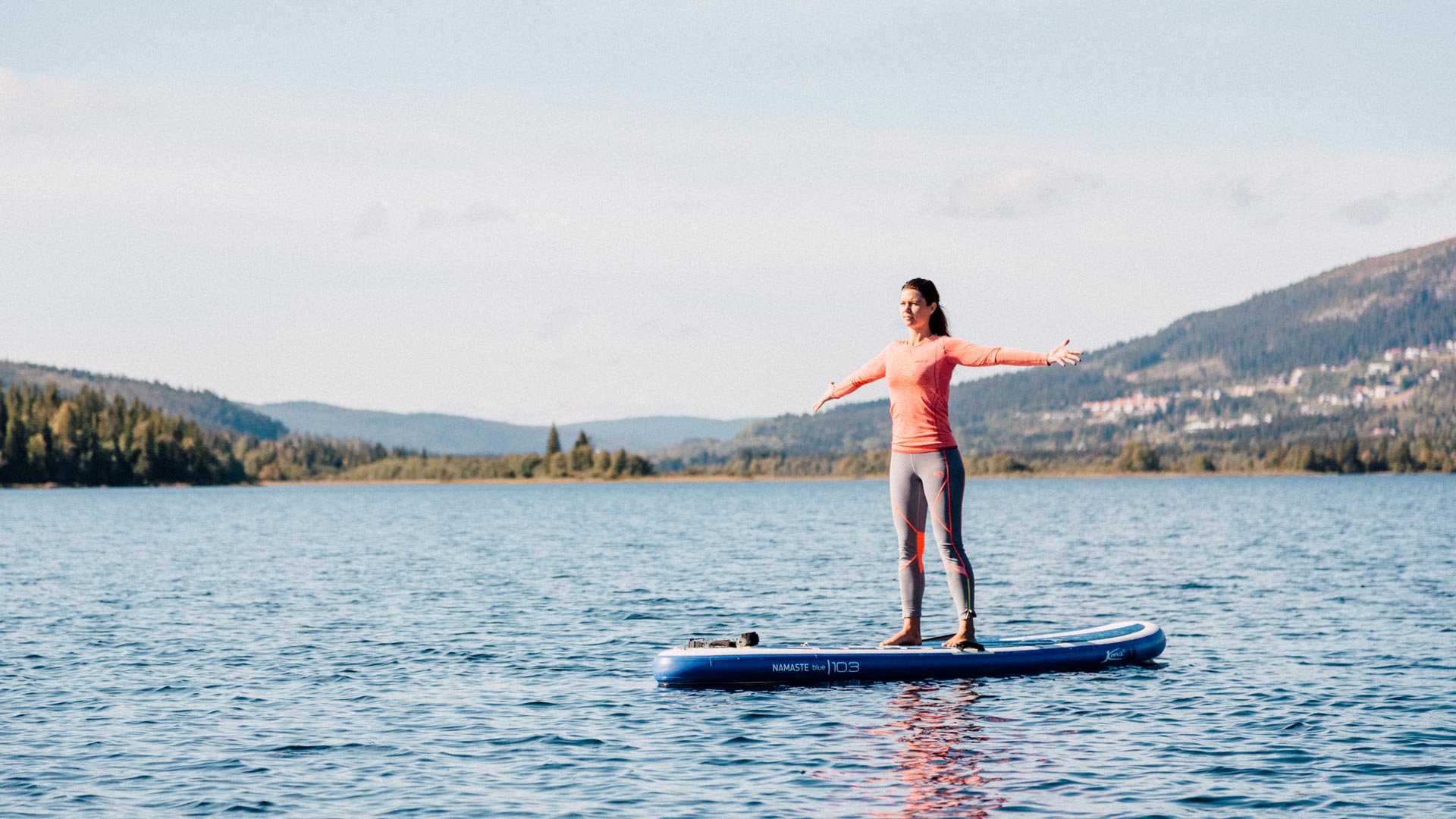 Woman standing free on a stand up paddle board