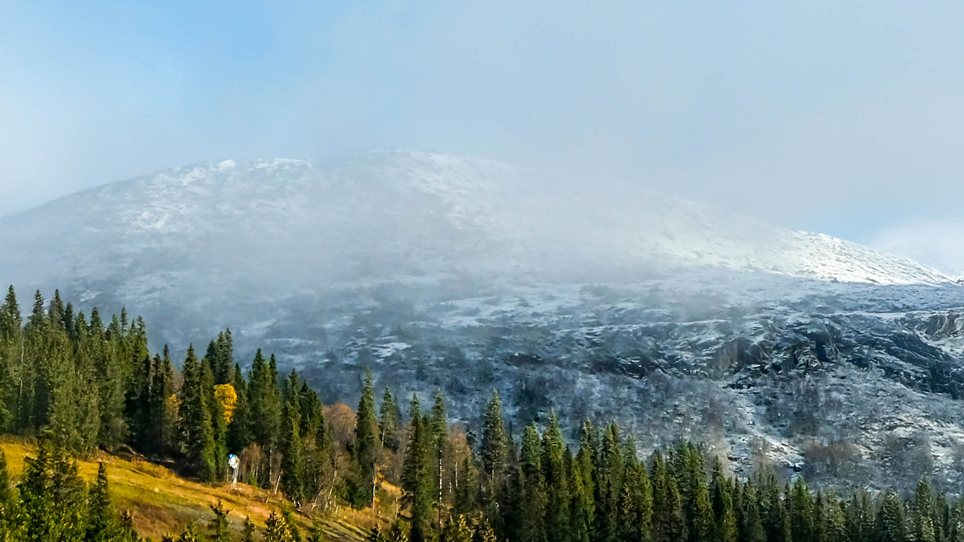 Åre med höst i lågzon och vita fjälltoppar