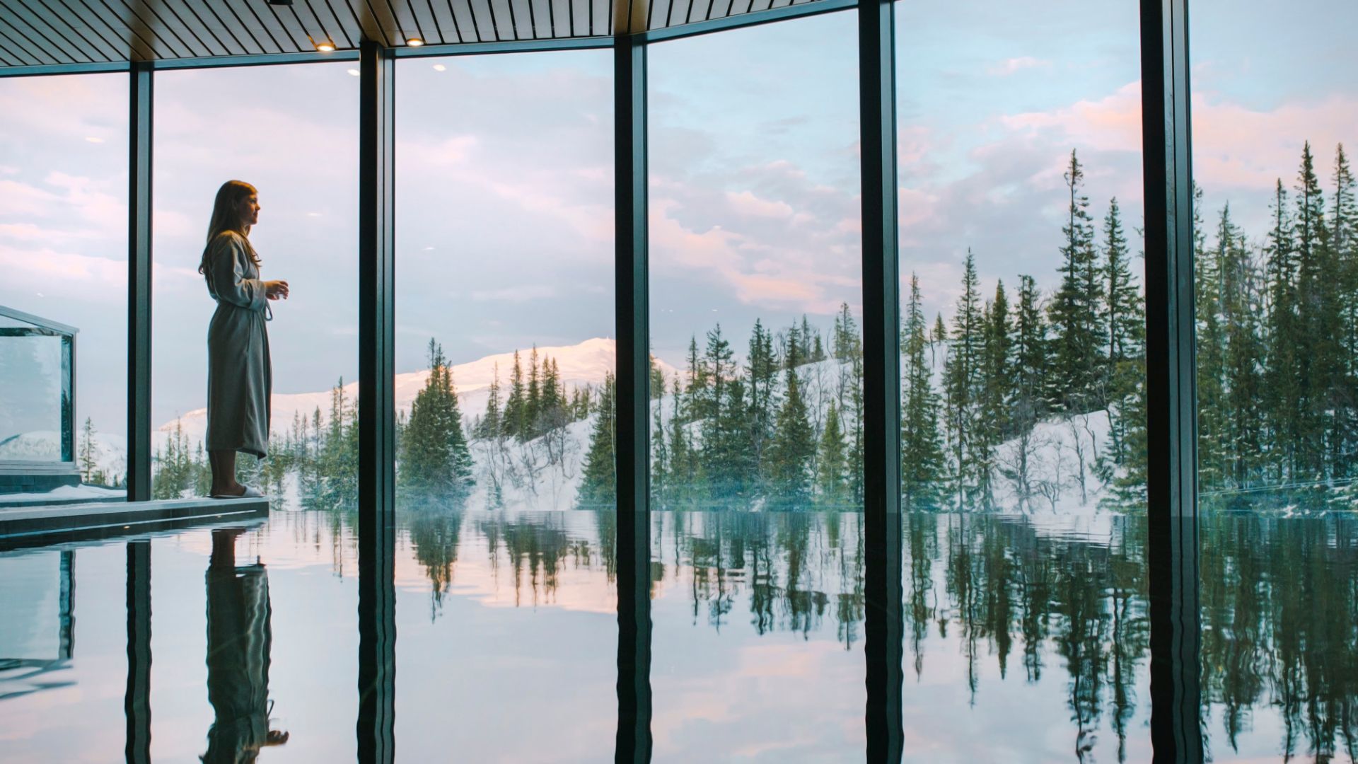 Woman stands in tranquility and enjoys the views from the spa at Copperhill Mountain Lodge.