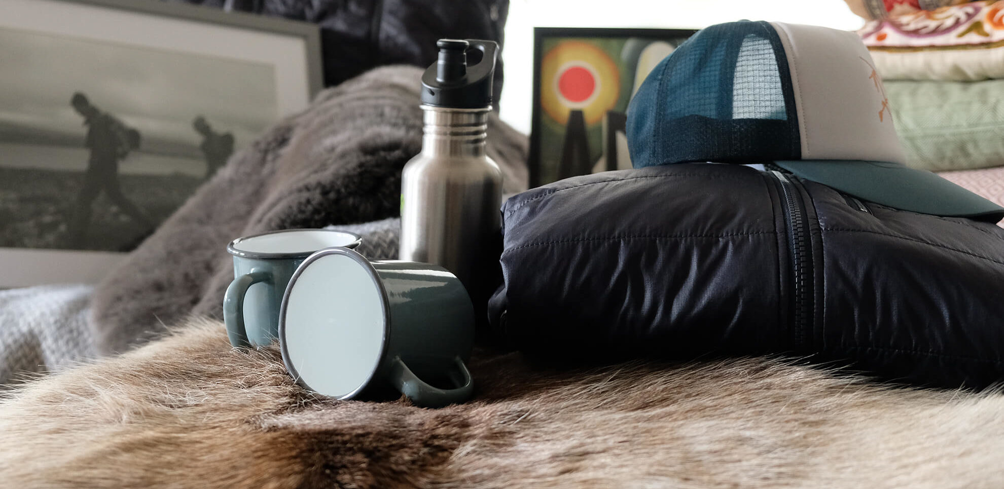 A cap, mugs, a jacket and a water bottle.
