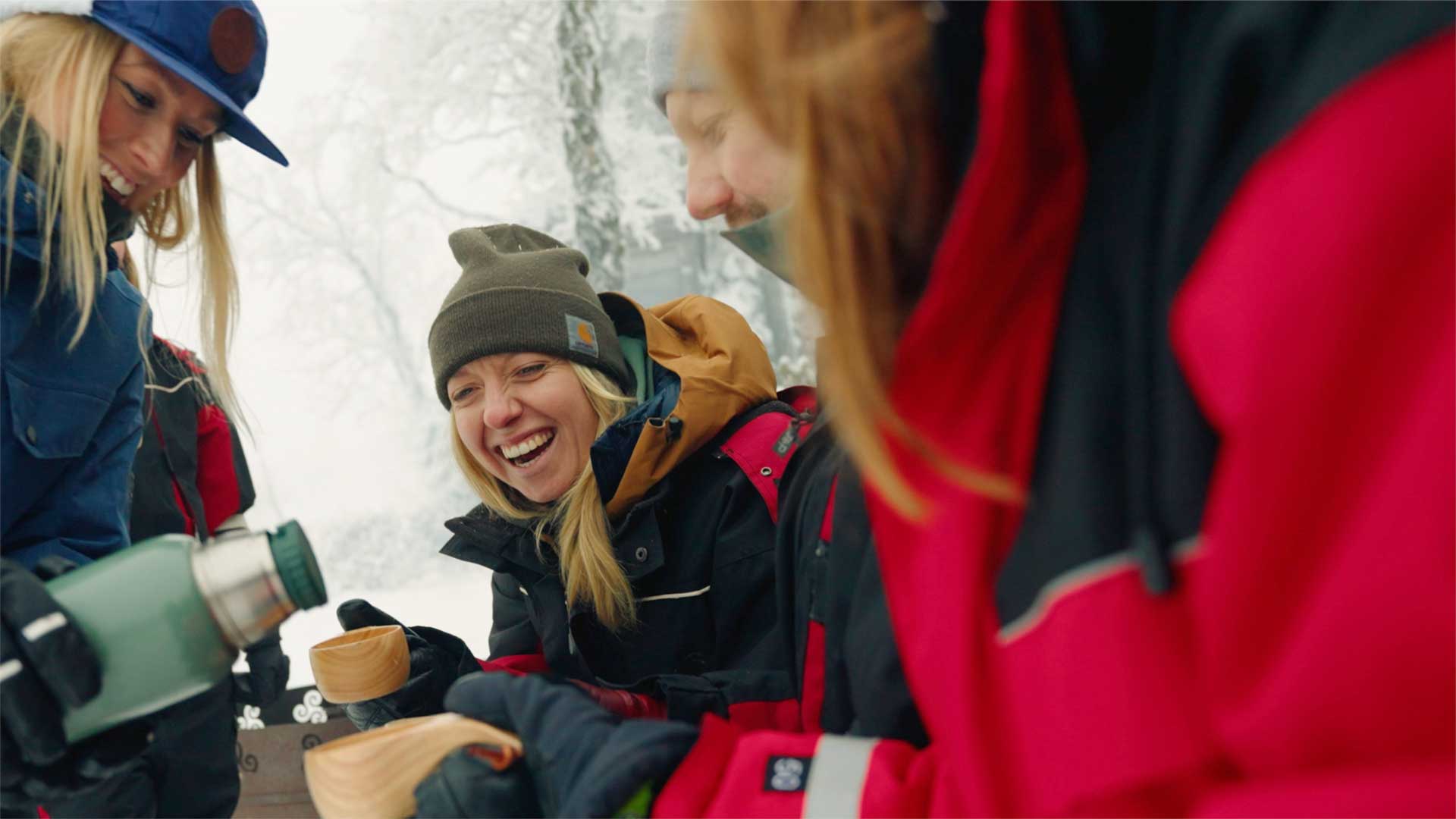 Happy people taking a Swedish fika outdoors