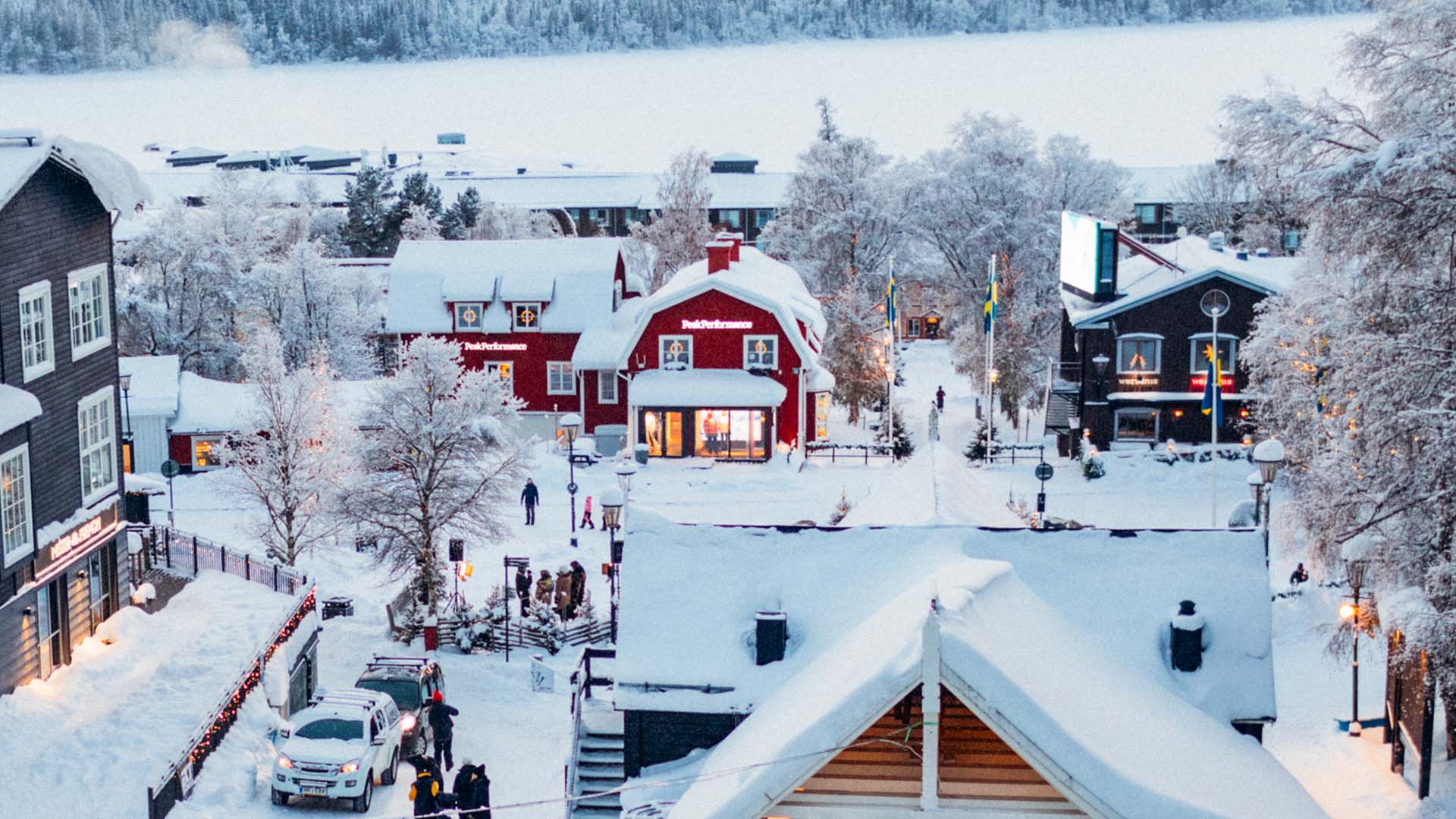A December day in Åre, with people gathering in Åre Square surrounded by holiday decorations and freshly fallen snow.