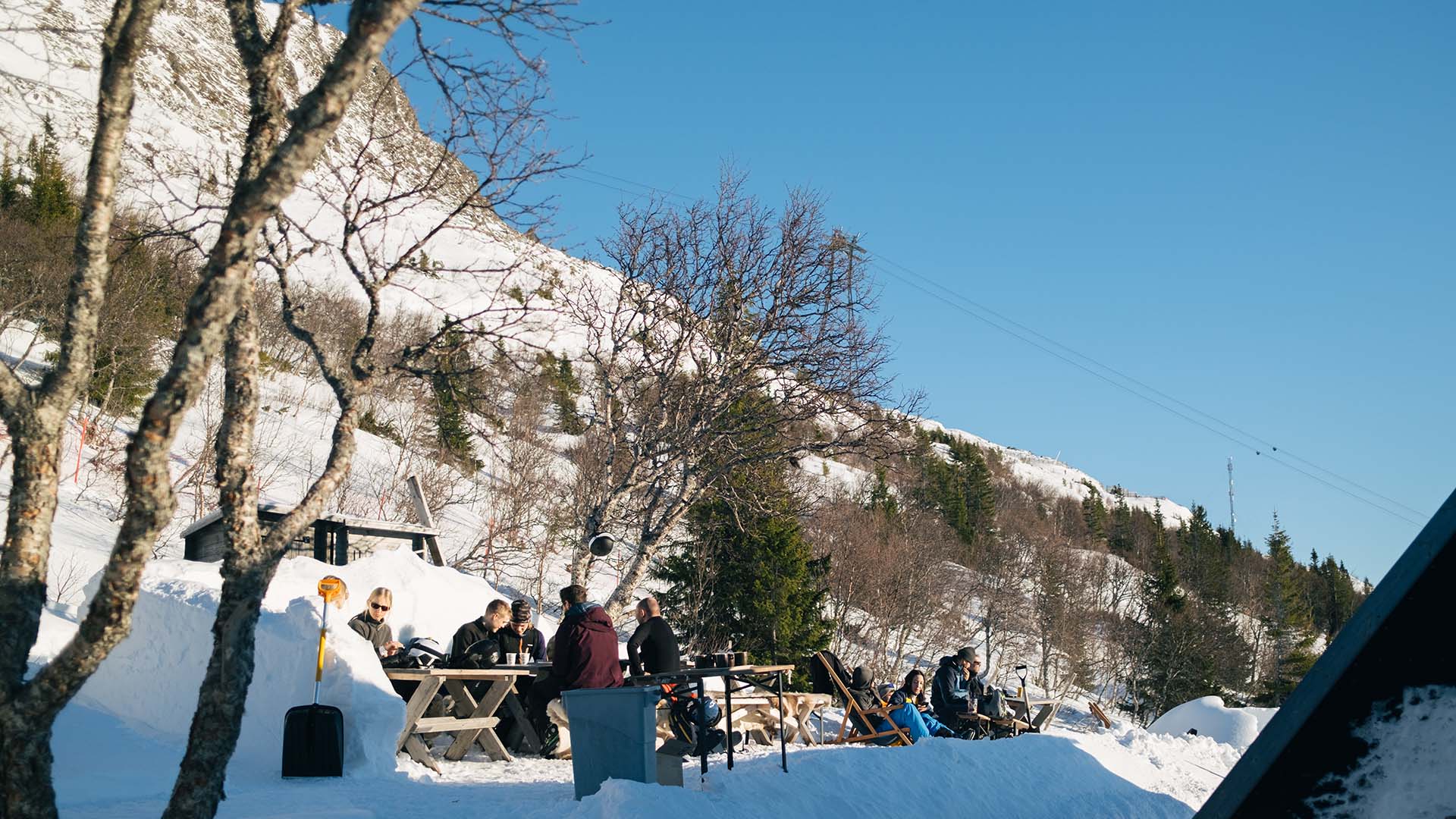 Skiers enjoying waffles outdoors in the spring sunshine.