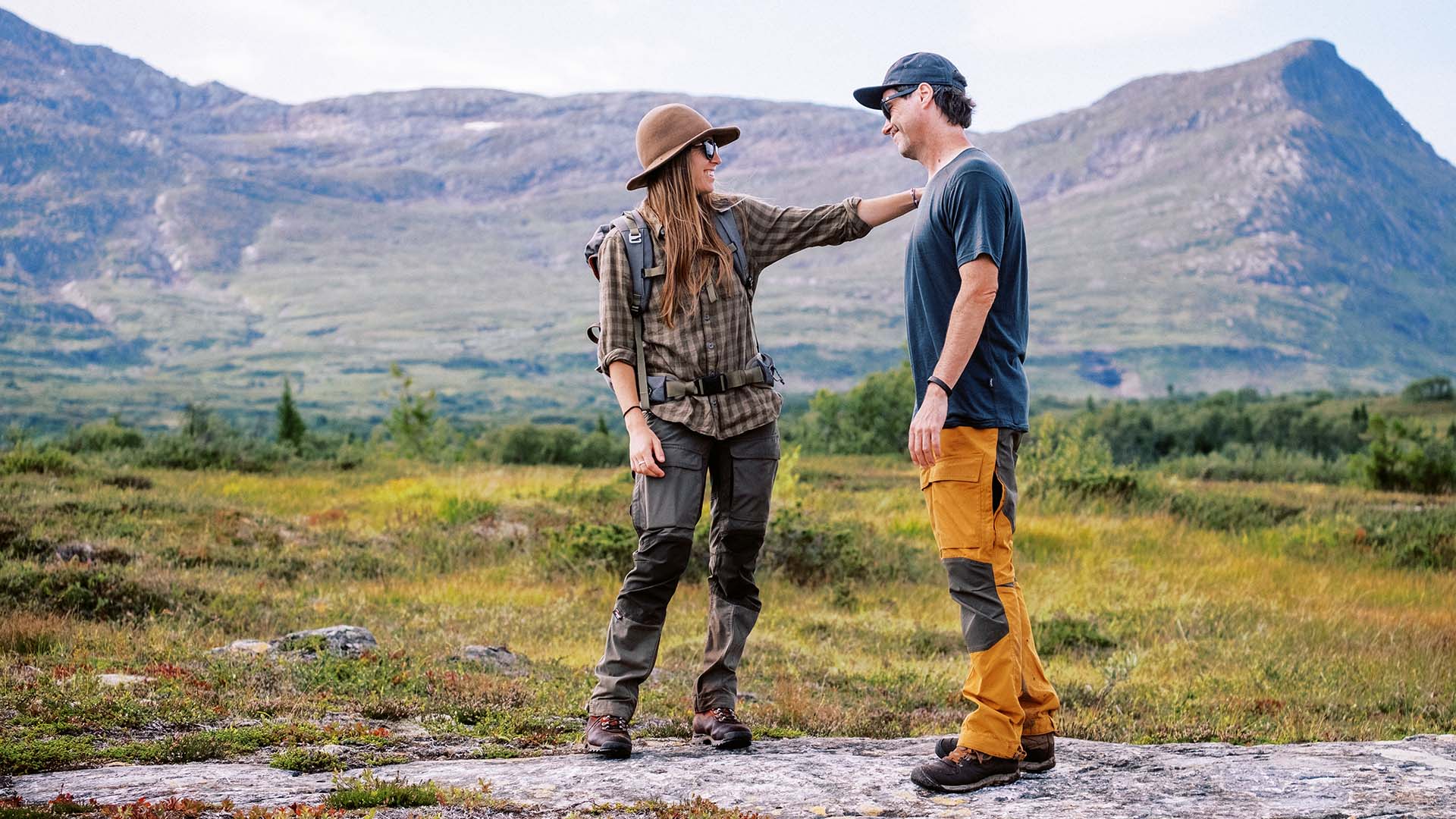 Woman pointing toward the view with her hiking partner beside her.