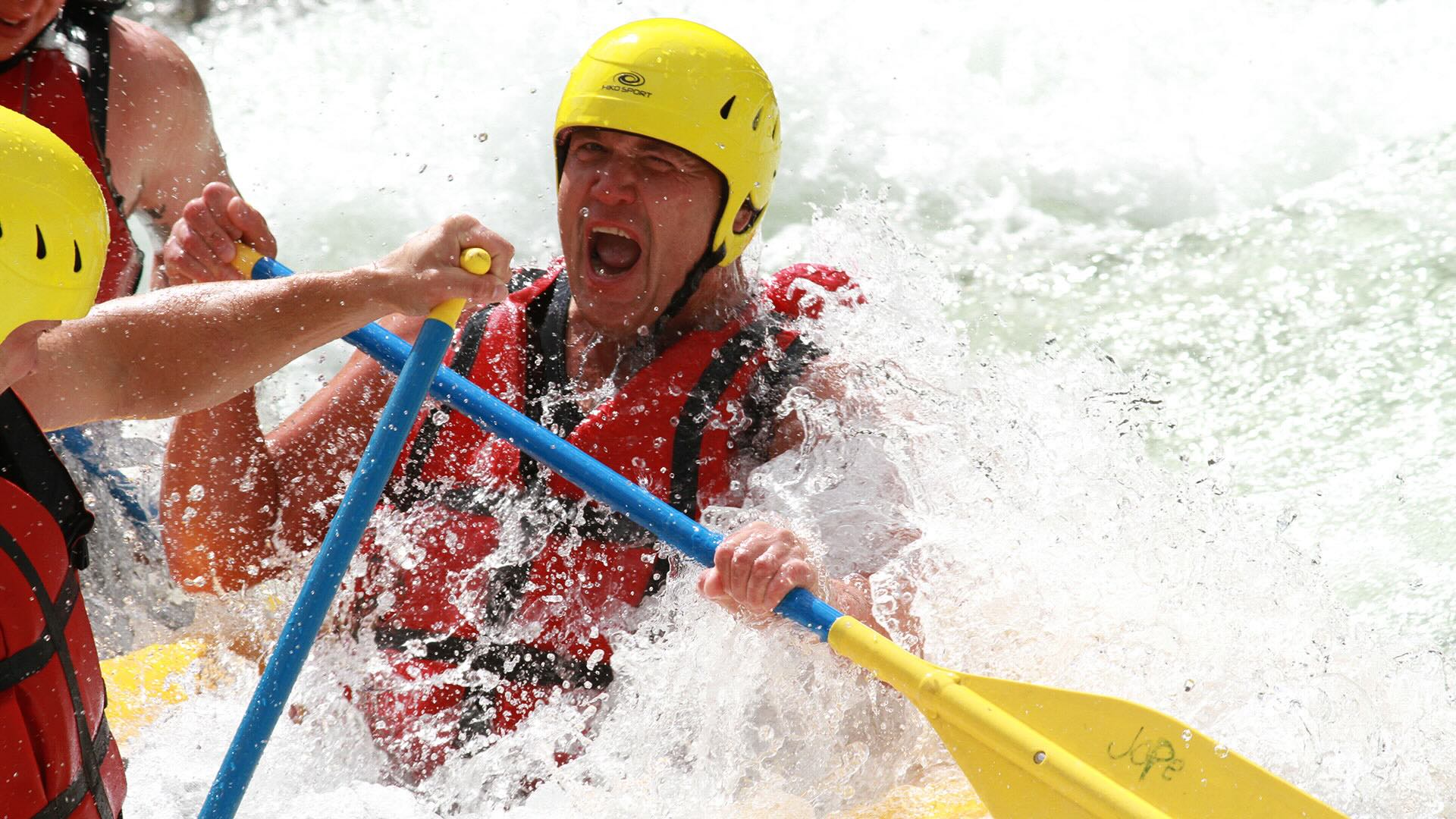 Person doing whitewater rafting adventure.