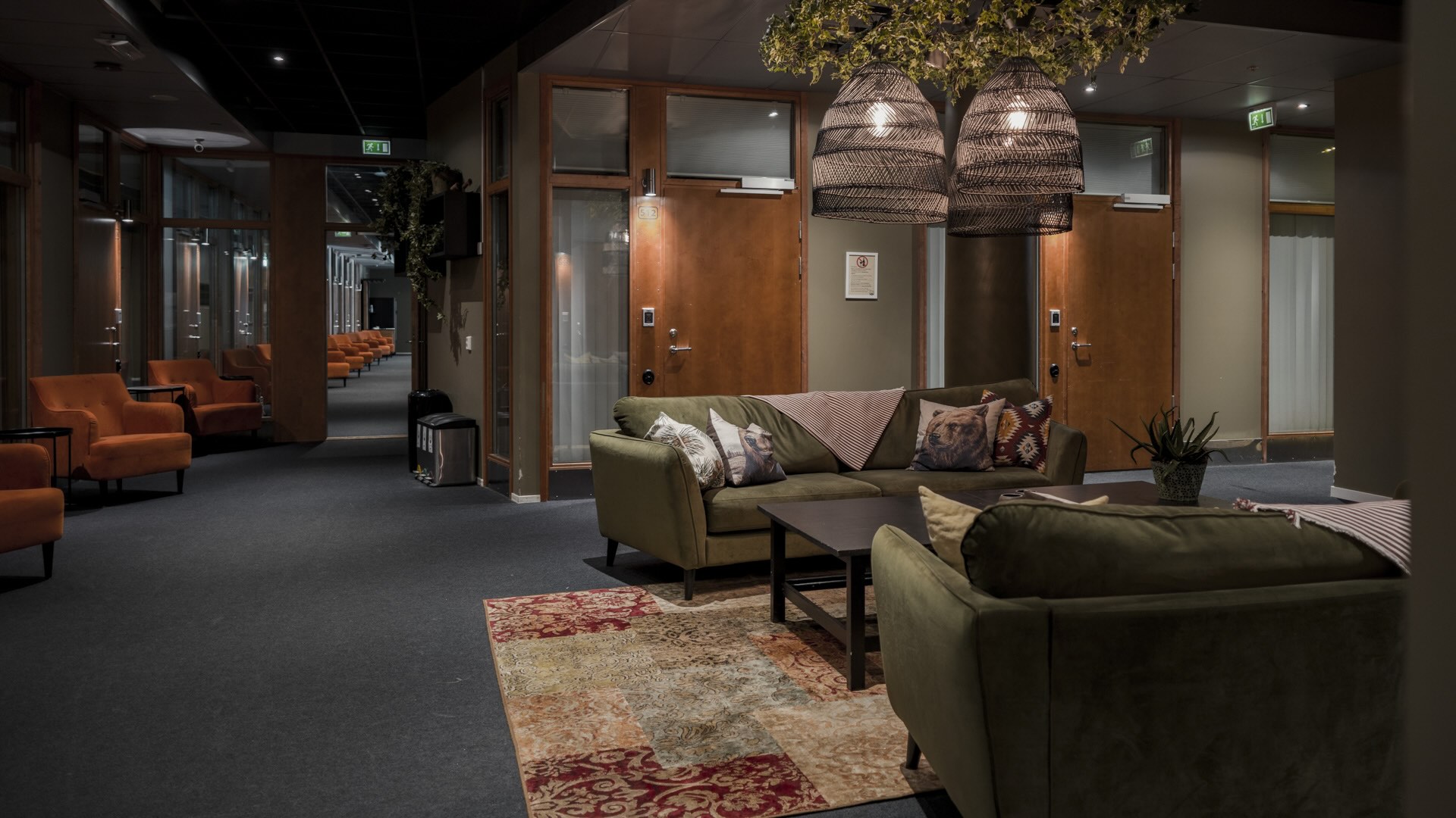 The cozy lounge at Åre Hostel, decorated in warm, dark tones.